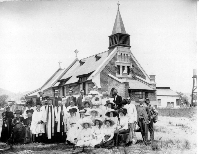 Old photo of church with a large group of people in front