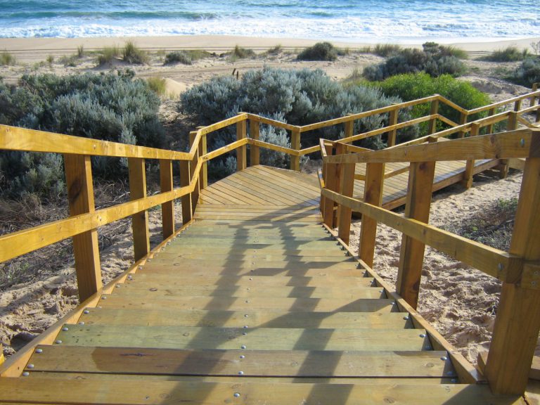 Image of stairs leading to golden sand and water at Buffalo Beach