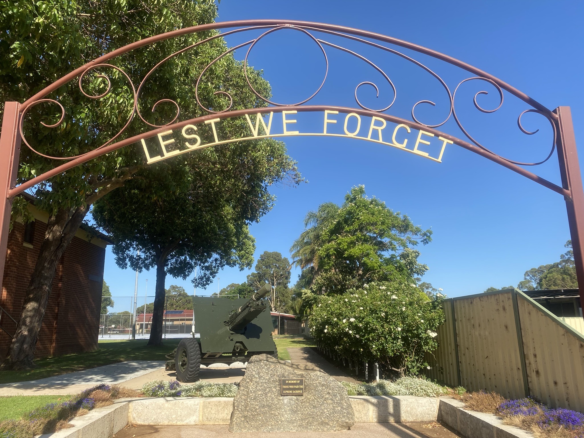 Image of the Brunswick Memorial Gate with the words Lest We Forget