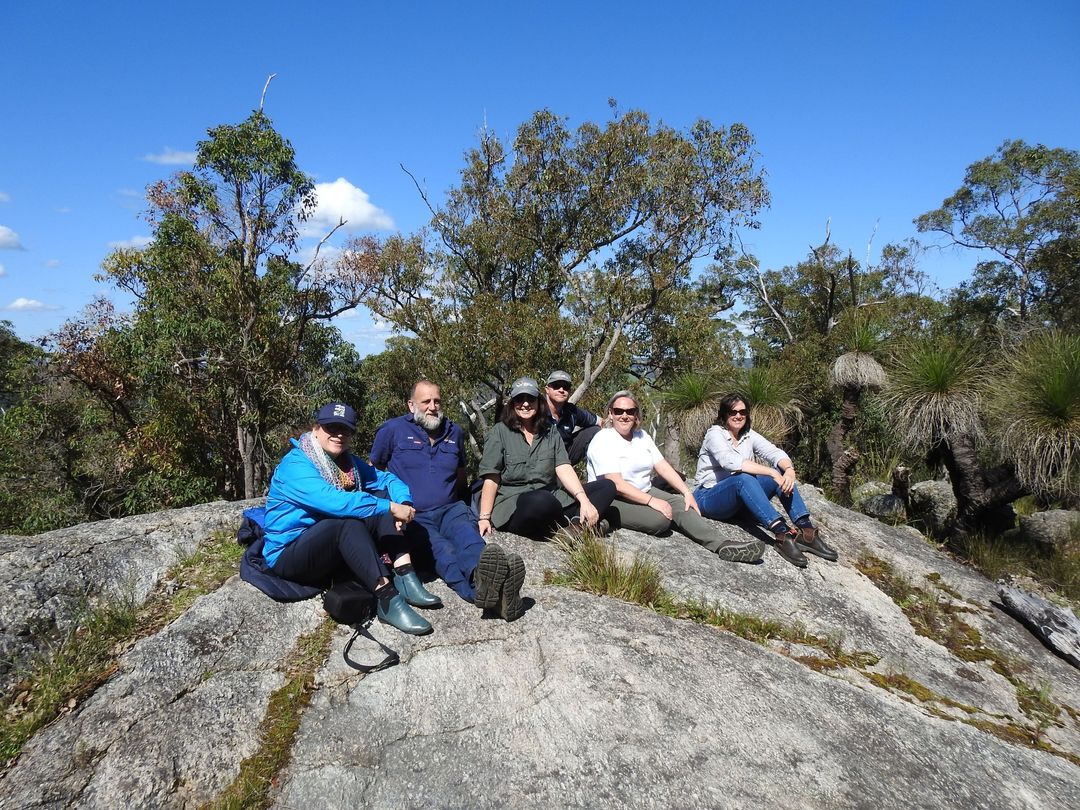 Image of people during a Mindful in Nature Tour sitting on rocks