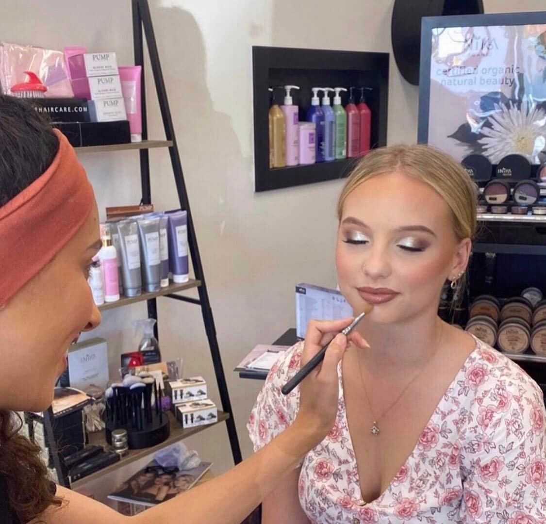 Image of a woman getting her makeup done