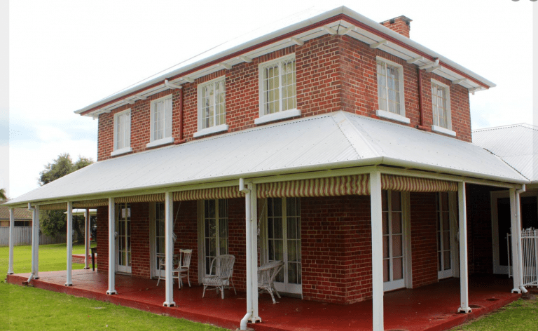 External image of Upton House with red brick and white window frames and poles
