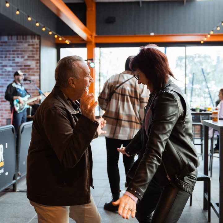 Image of two people dancing to live music