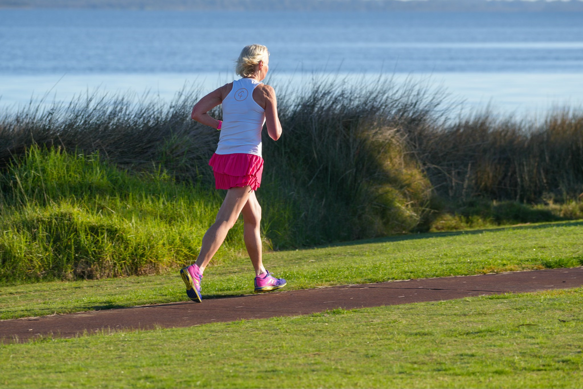 Image of a woman running along the Ridley Place Foreshore