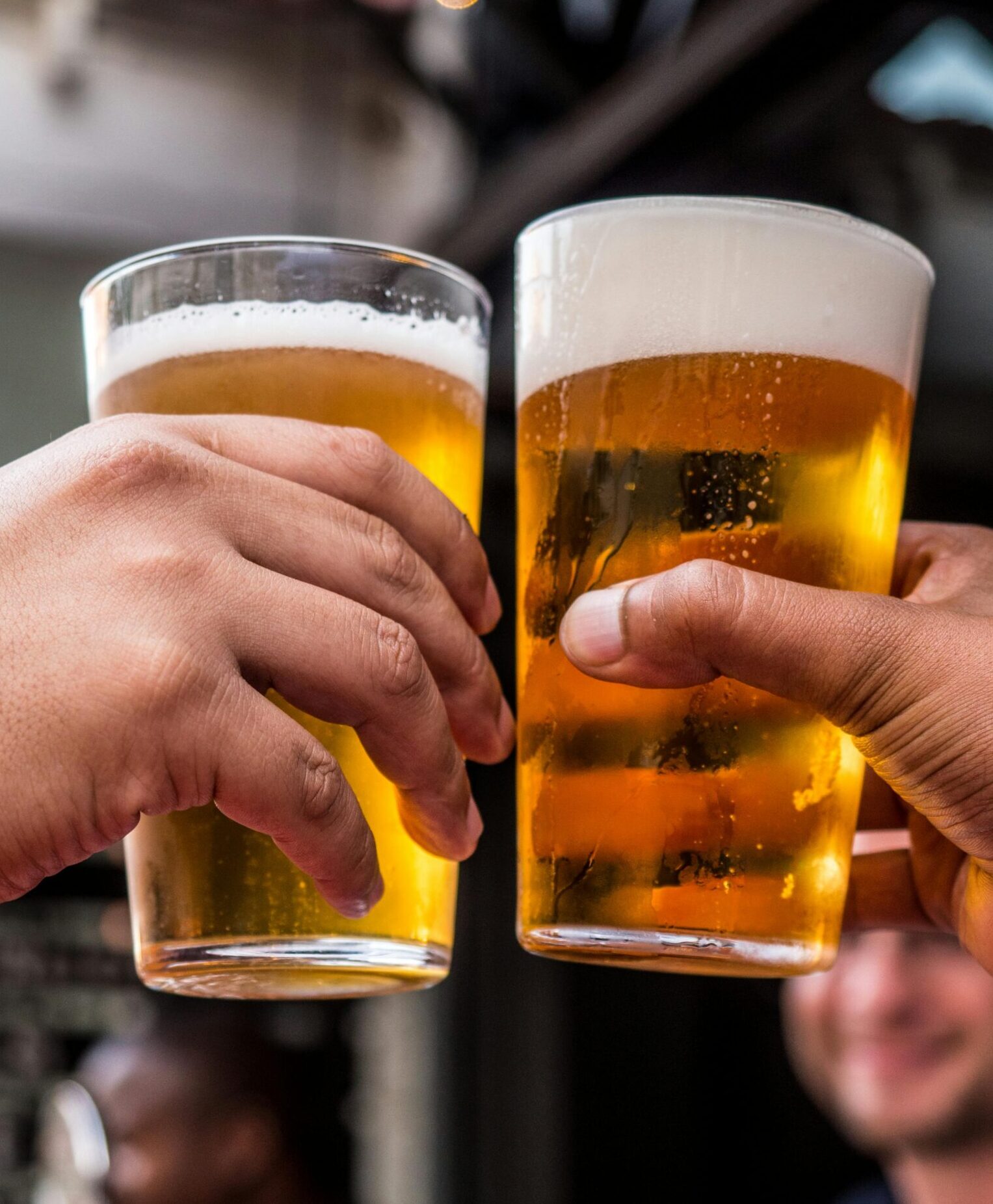 Image of two glasses of beer cheersing