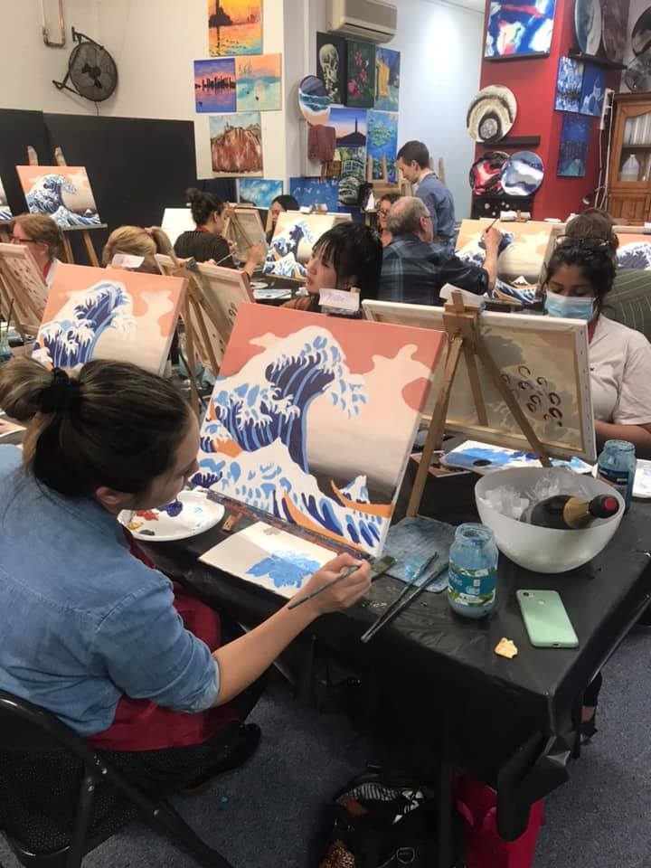 Image of ladies painting and sipping