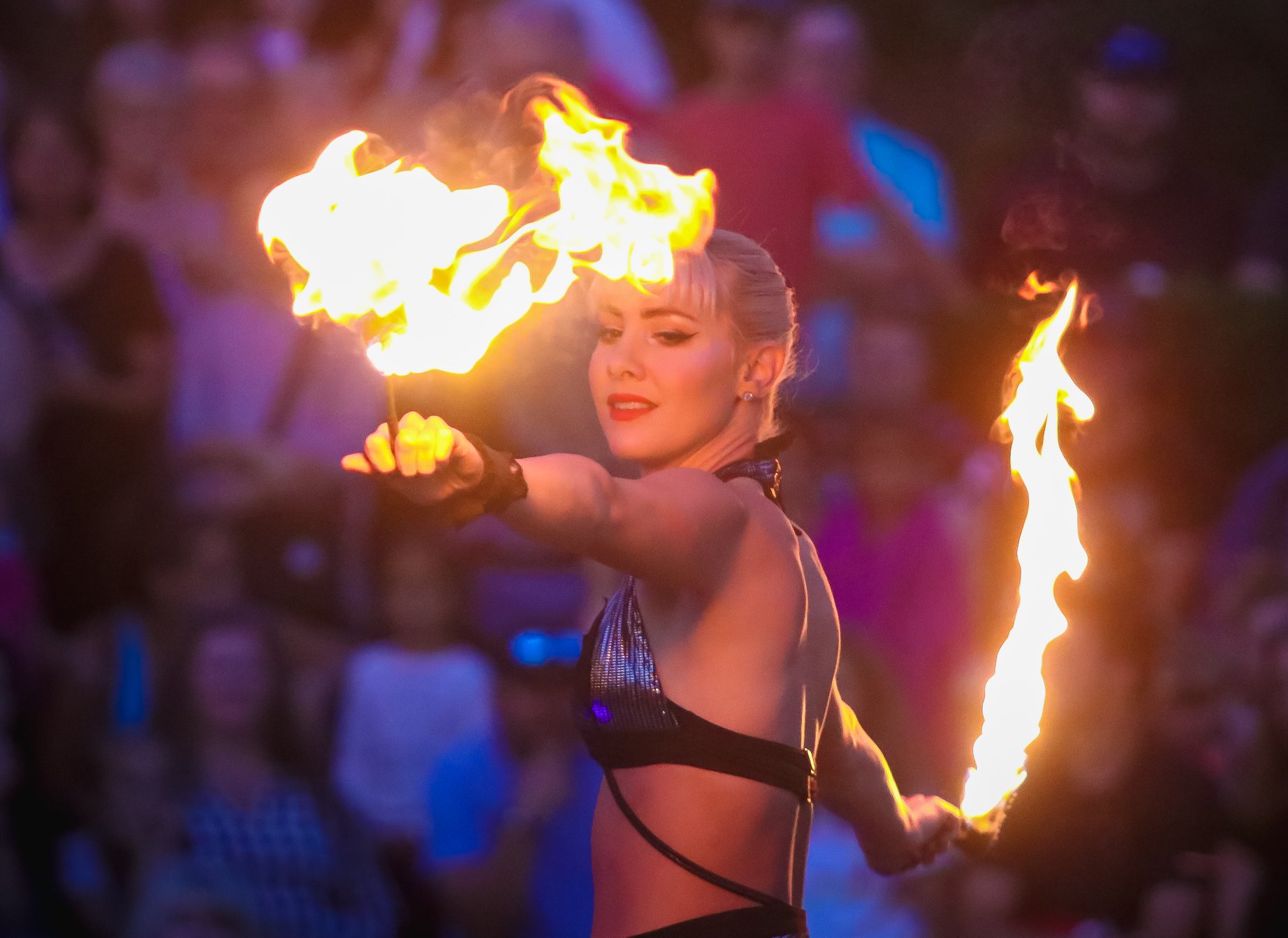 Image of a woman with fire poi's